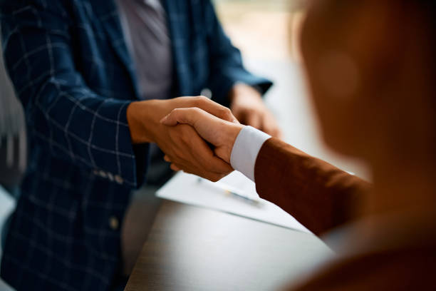 Homeowner and Webster Homes representative shaking hands after a cash home sale in Florida